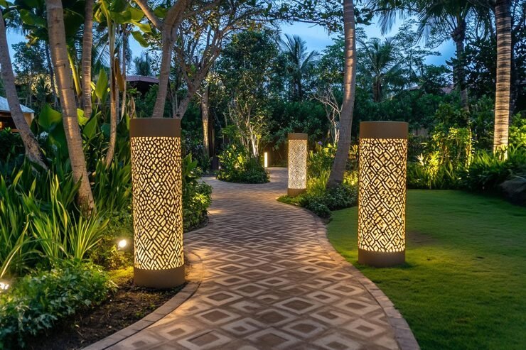 Lit garden pathway with decorative bollard lights at dusk