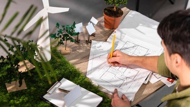 Landscape designer sketching a garden plan with scale models